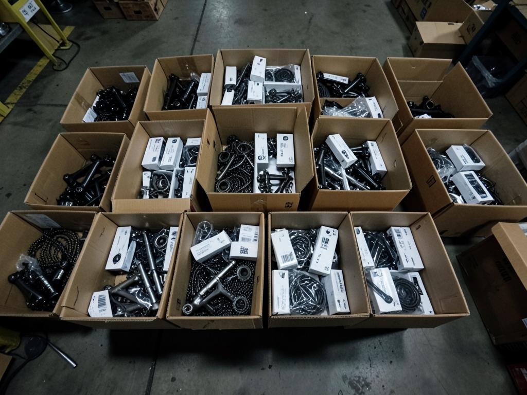 Open boxes of bulk-packed OEM bicycle components