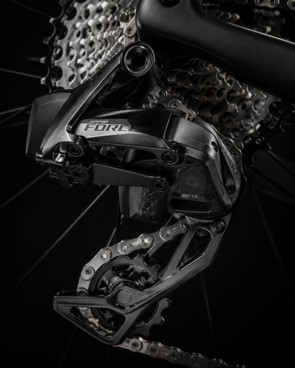 Bicycle crankset, cassette and derailleur components on a dark background
